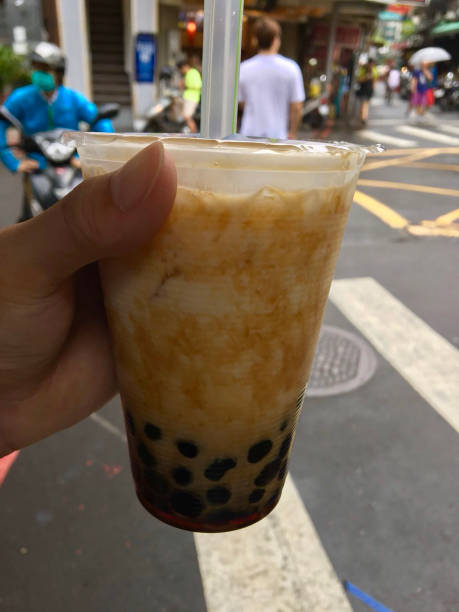 istock Image of bubble tea drink with straw in plastic cup, girl’s hand 1131630683