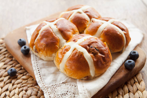 Hot Cross Bun for Easter Easter Hot Cross Buns for breakfast traditional celebration and blueberries. sweet bun stock pictures, royalty-free photos & images