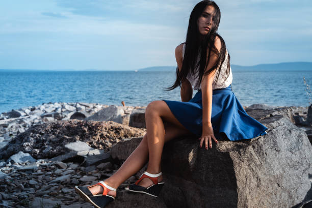 istock A woman sitting on a rock 1131630960