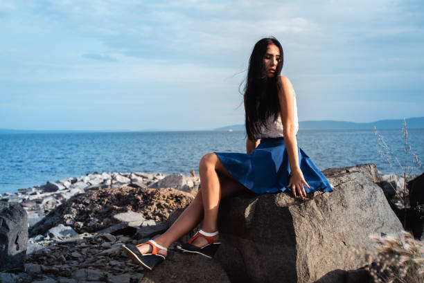 istock A woman sitting on a rock 1131630965