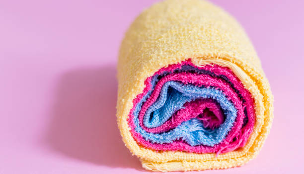istock colored towels rolled up, pink background 1131631883