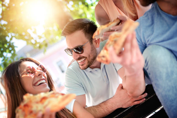 istock Cheerful friends eating pizza 1131631990