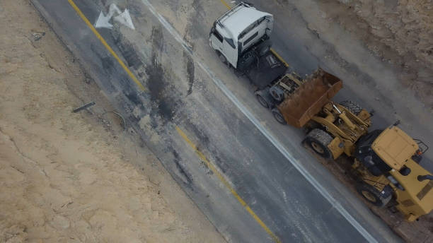 istock Cargo tranporting constuction eauipmet by desert road with mountains 1131632110