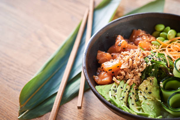 istock Poke bowl on wooden background 1131632142
