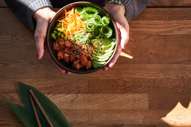 istock Woman holding poke bowl 1131632201