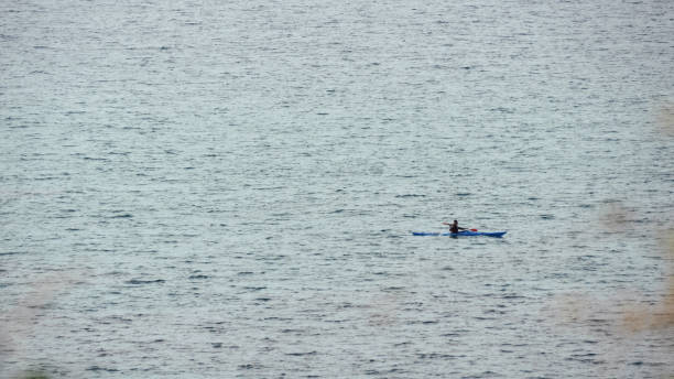 istock Man in row boat at open sea 1131632554