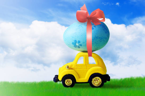 istock Retro toy car with Easter egg on the roof on spring background. Easter concept. 1131634439