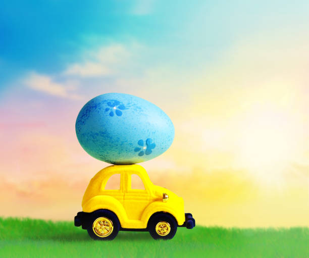 istock Retro toy car with Easter egg on the roof on spring background. Easter concept. 1131634464