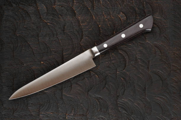 istock Stainless steel knife on black cutting board 1131634796
