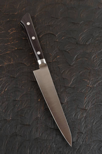 istock Kitchen knife on dark wood 1131634811