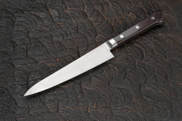 istock Stainless steel knife on black cutting board 1131634812