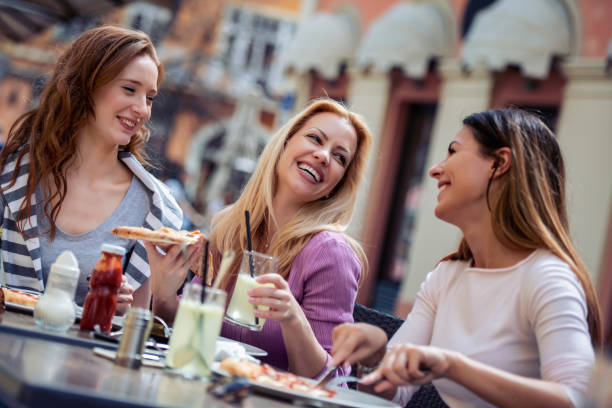 istock Smiling friends enjoying in cafe 1131635791
