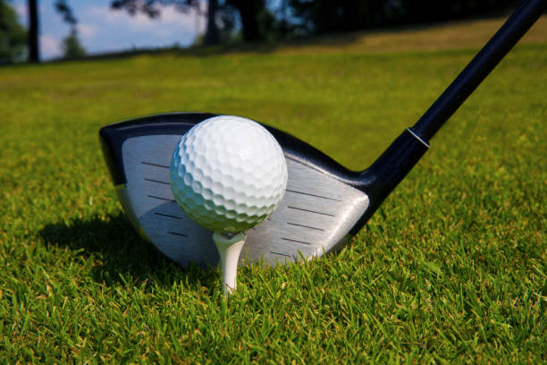 istock Golf ball and driver on tee of golf course. 1131635936