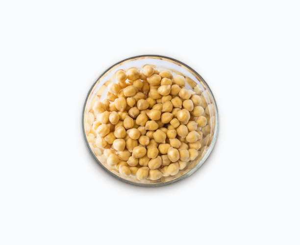 istock Chickpea soaked in water in a bowl on a white background. Chickpea isolated on white background. Chickpeas soaked in water. Chickpea in a bowl isolated on white. 1131636032