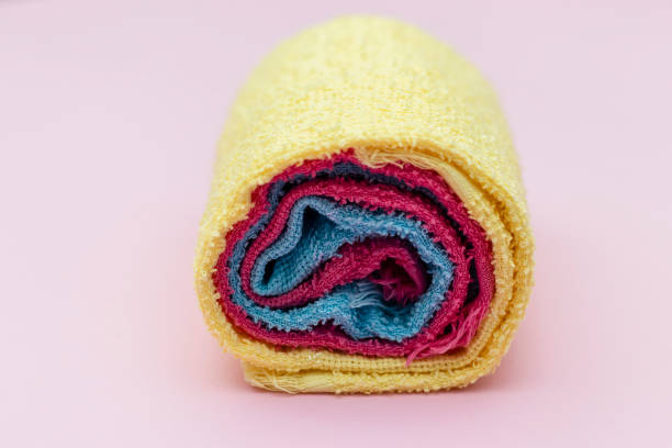 istock colored towels rolled up, pink background 1131636132