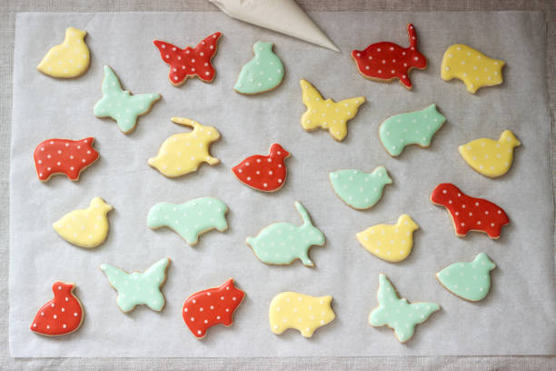 istock Gingerbread or shortbread cookies of various shapes, covered with colored icing. Spring or summer composition. 1131636662