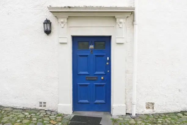 Blue old wooden door rustic ancient house entrance in Culross uk