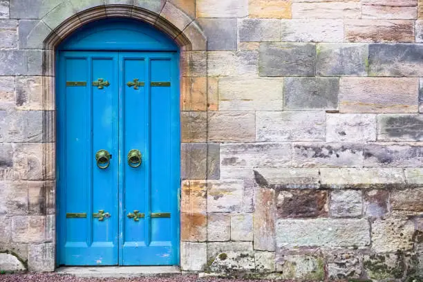 Blue old wooden door rustic ancient house entrance in Culross uk