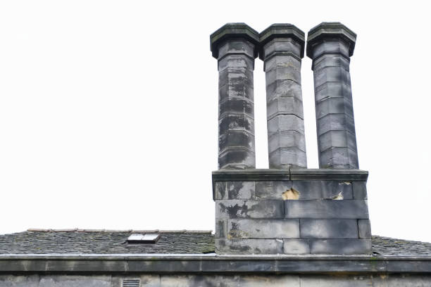 Three chimney pots in set off 3 on old century building London uk
