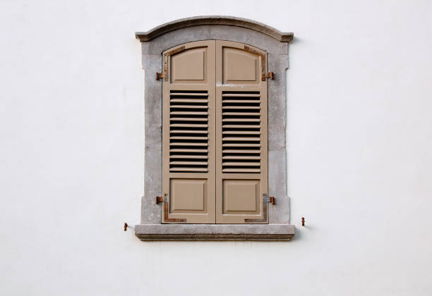 istock arched window with wooden shutters on a white wall 1131644168