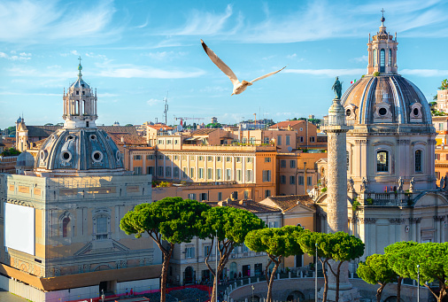 Trajan's column and churches in Rome at sunset