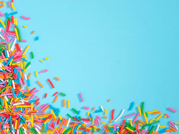 istock Border frame of colorful sprinkles on blue background 1131644972