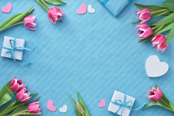 istock Springtime flat lay with giift boxes, pink tulips and decorative hearts, copy-space 1131648700