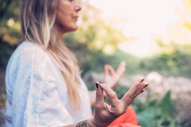 istock Mature Woman Meditating in Nature 1131651373
