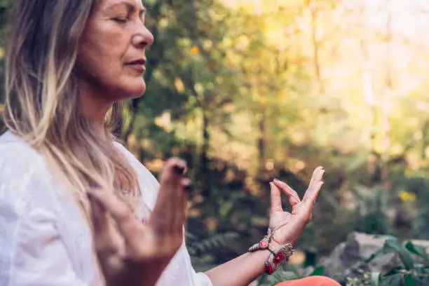 Photo of Mature Woman Meditating in Forest