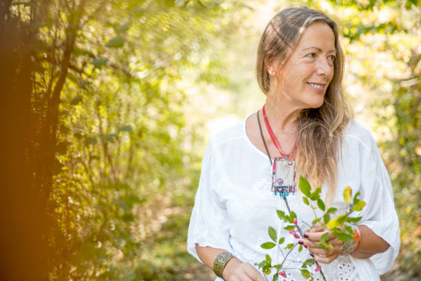 istock Smiling Mature Woman Walking in Forest 1131651389