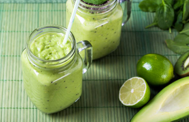 istock Green smoothie on green background made by avocado, lemon and kiwi. 1131651507