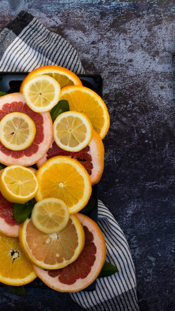 istock Sliced citrus fruits on black ground 1131652565
