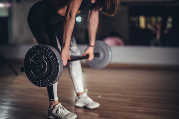 istock Woman with barbell 1131654546