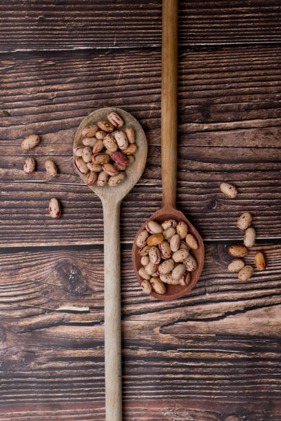 istock Organic Colorful Beans on Dark Wooden Background 1131655930
