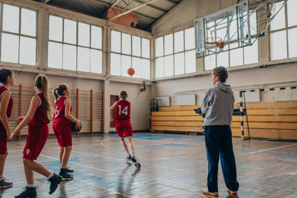 istock Female coach with basketball team 1131657392