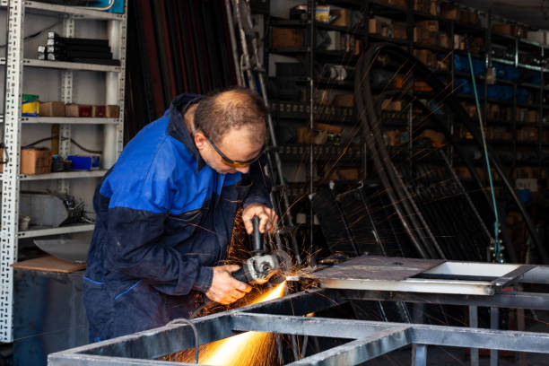 istock Construction industry manual workman cutting iron with circle saw 1131657888
