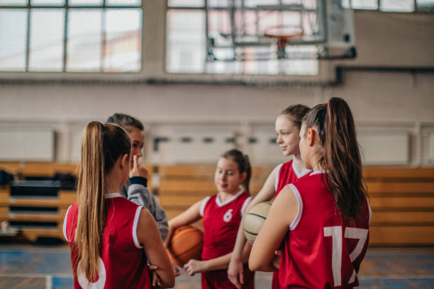 istock Female coach with basketball team 1131657992