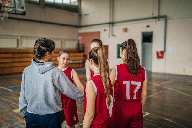 istock Female coach standing with basketball team 1131658995