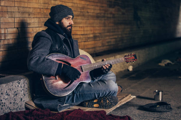 istock Man playing guitar in underpass tunnel 1131660783