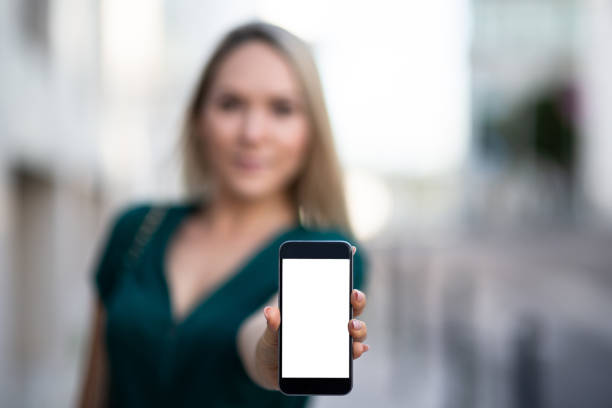 istock Woman showing a blank smartphone screen 1131661627