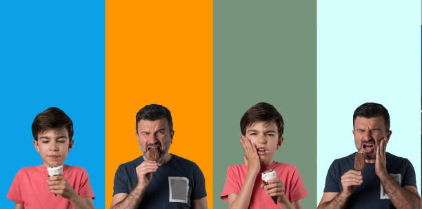 mann und junge erleben zahnschmerzen - child chocolate ice cream human mouth stock-fotos und bilder