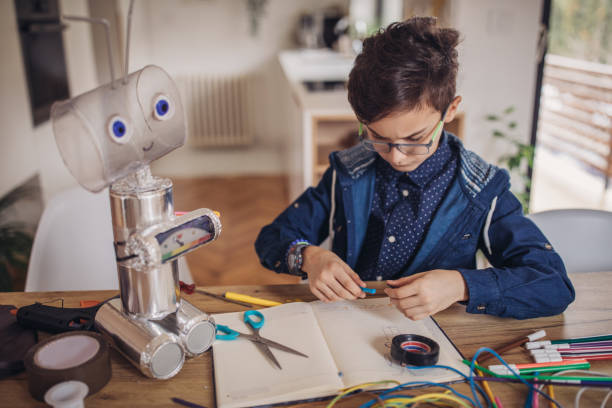 istock Little boy making robot toy for school project 1131664365