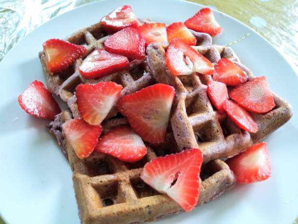 istock Mixed berries waffel topped with slices strawberry 1131668719