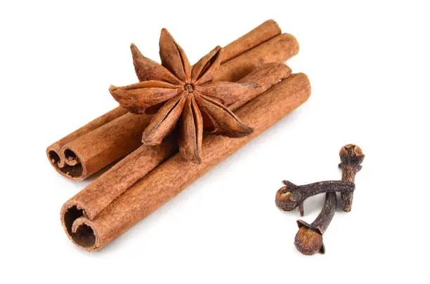 Set spices. Star-anise, cinnamon sticks and buds cloves on a white background. Isolated, close-up.