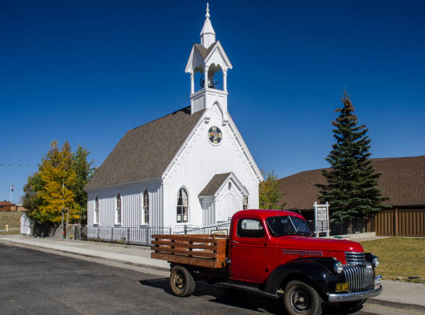 Fairplay, Colorado, USA - September 22, 2018: A white Victorian Church with a Bell Tower and Steeple in the town of Fair Play, Colorado which was founded in 1859. A historic gold mining settlement, the town was founded during the early days of the Pike's Peak Gold Rush. During the summer of 1872, the church was founded with a congregation of eight and was named the First Presbyterian Church of Fairplay; later to be renamed the South Park Community Church.