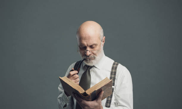 istock Senior academic professor reading and smoking a pipe 1131673337