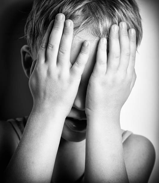 istock Sad crying little boy covers his face with hands 113167386