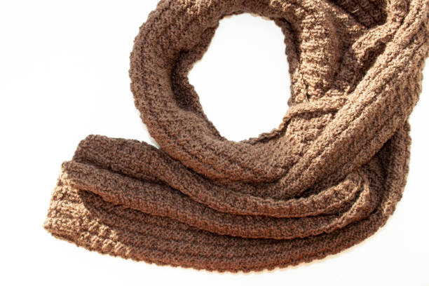 istock Brown knitted scarf on white background 1131675523
