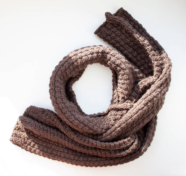 istock Brown knitted scarf on white background 1131675529