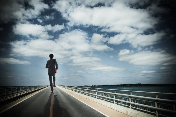 istock Businessman walking a straight road 1131678728